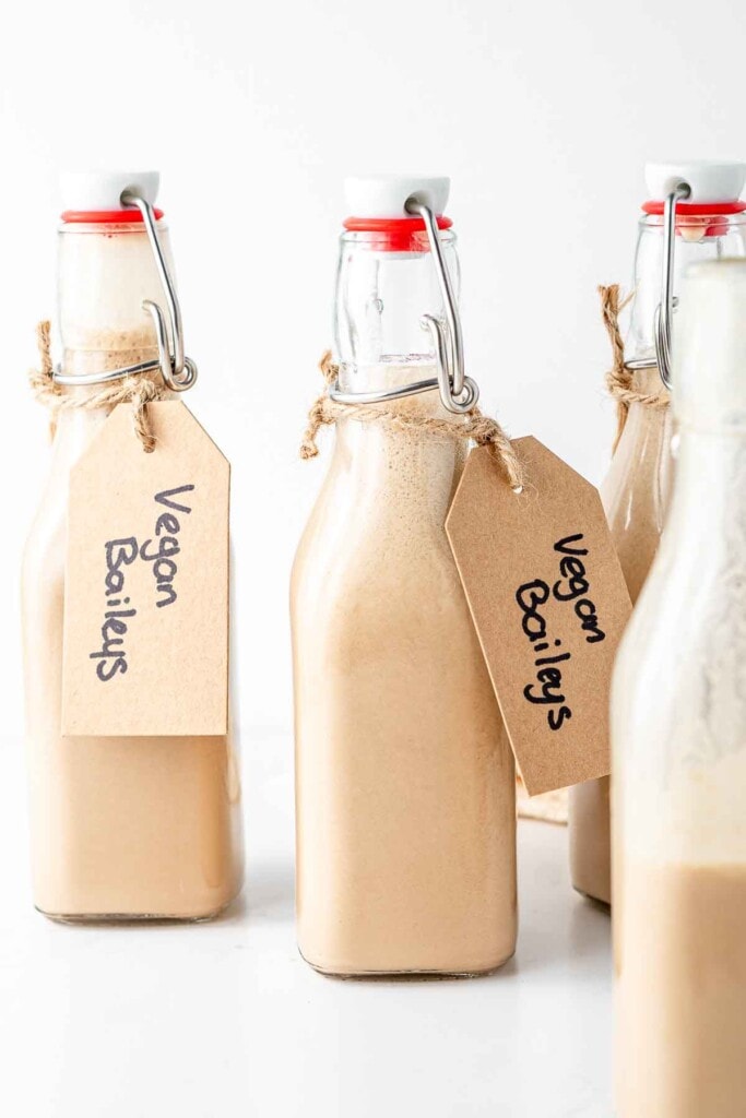Bottles of vegan baileys with gift tags.