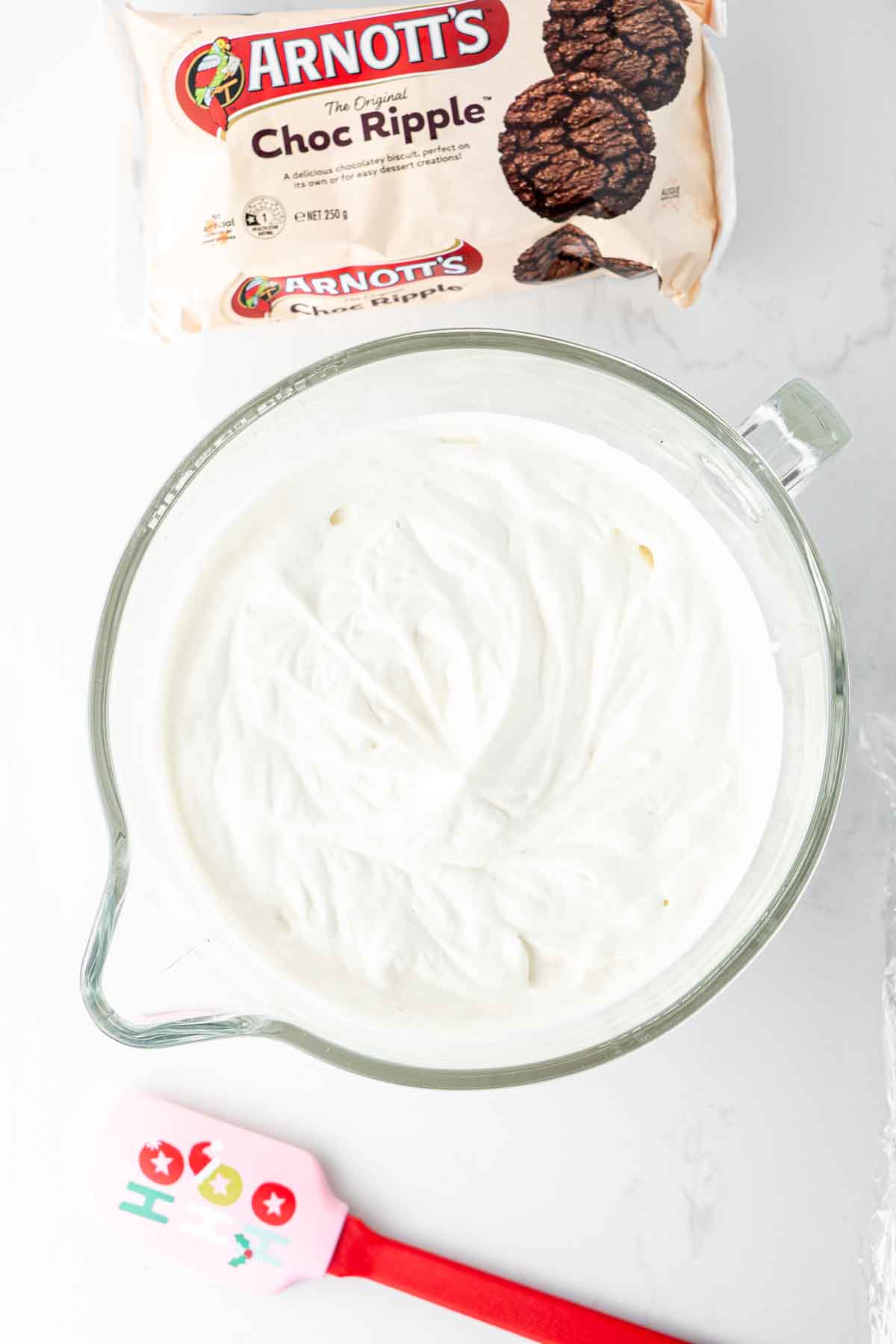 Whipped plant based cream in a mixing bowl.