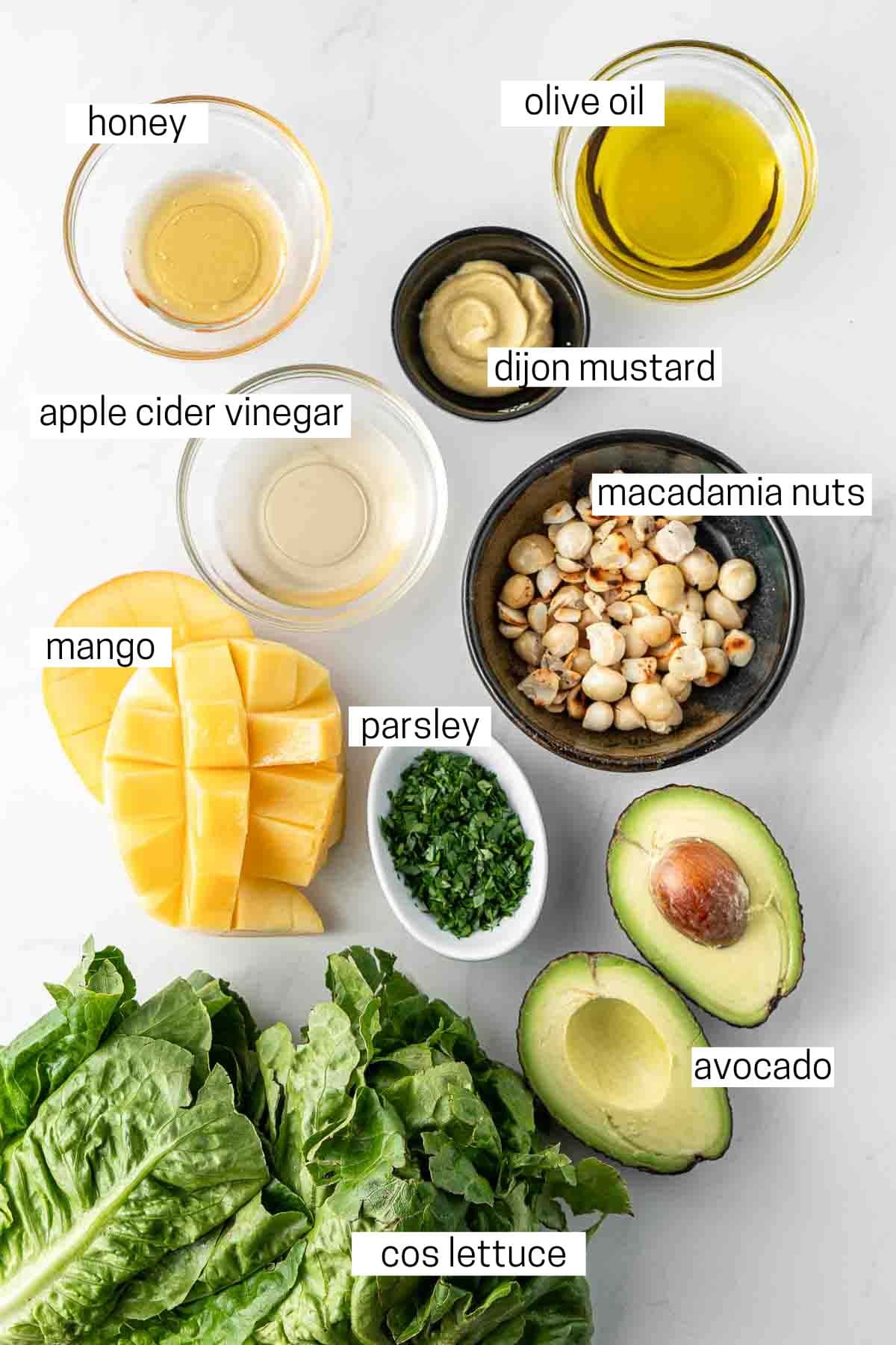 All ingredients for avocado and mango salad laid out in small bowls.