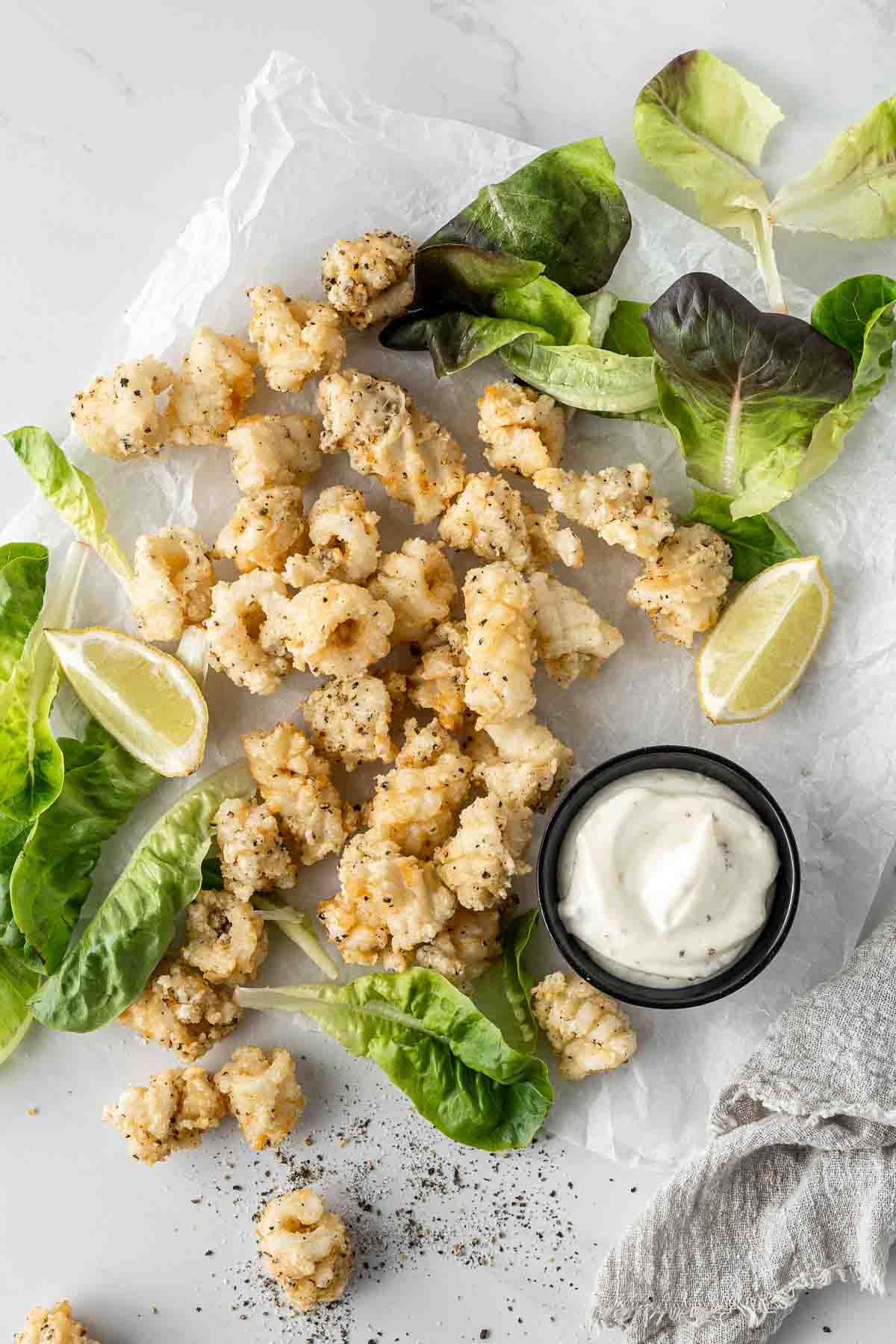 Salt and pepper squid with lemon, salad and aioli. 