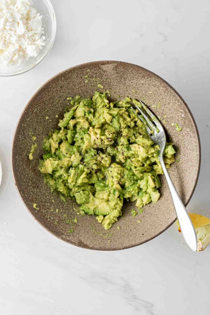Smashed avocado in a bowl.