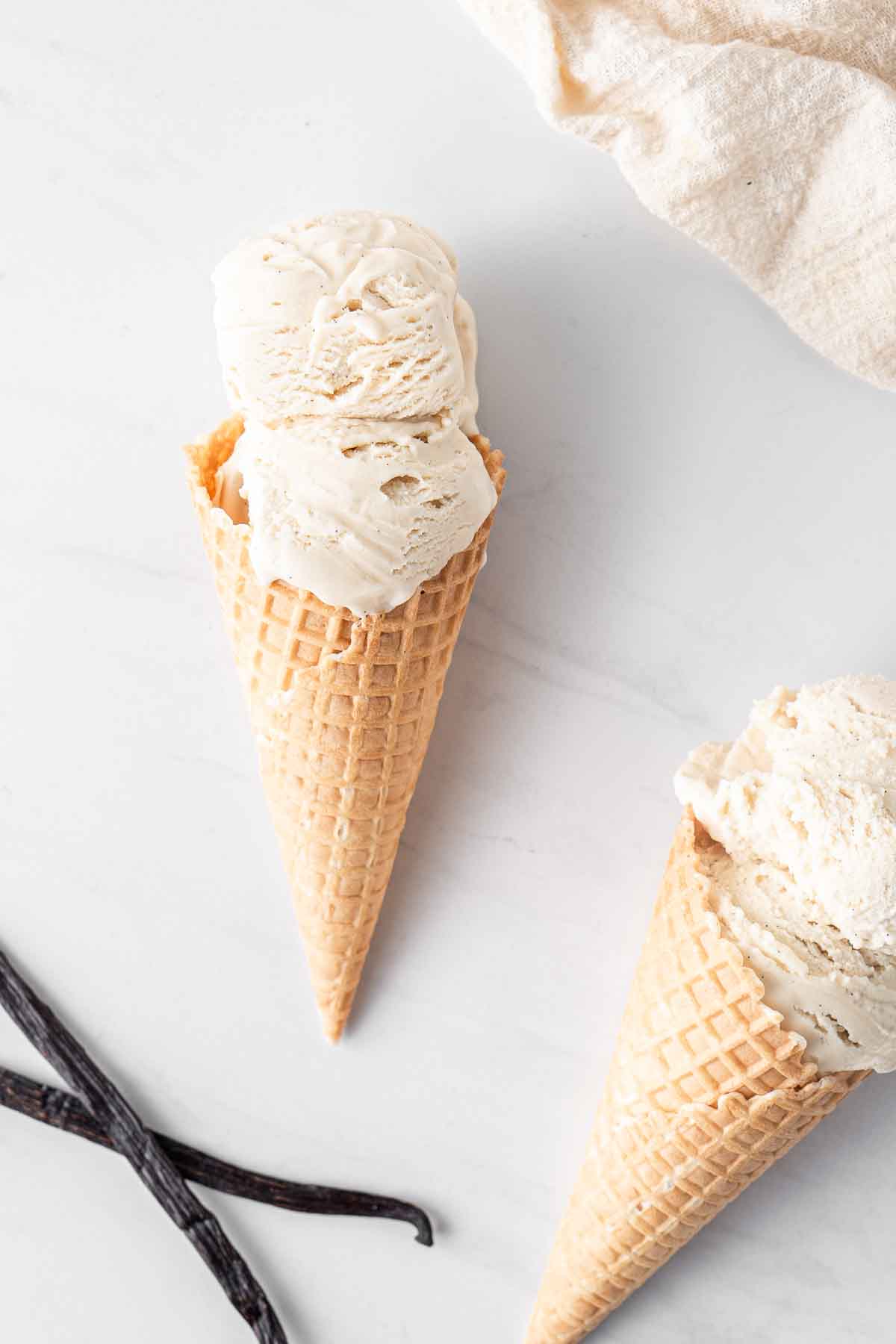 Ice cream cone with 2 scoops of vanilla ice cream.
