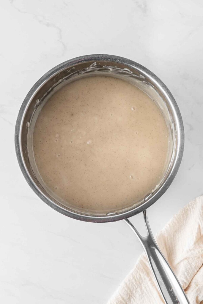 Making vegan vanilla custard in a small saucepan.