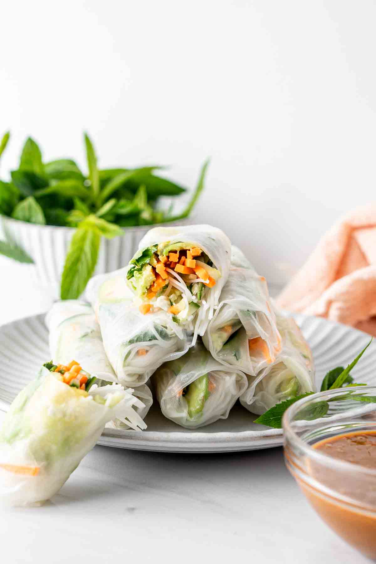 Rice paper rolls on a white plate.