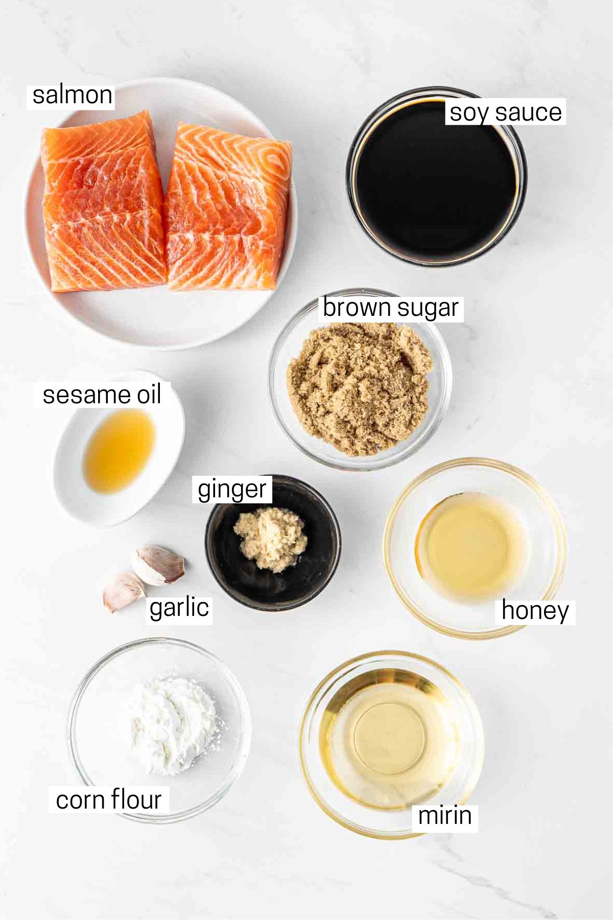 All ingredients needed for air fryer teriyaki salmon aid out in small bowls.