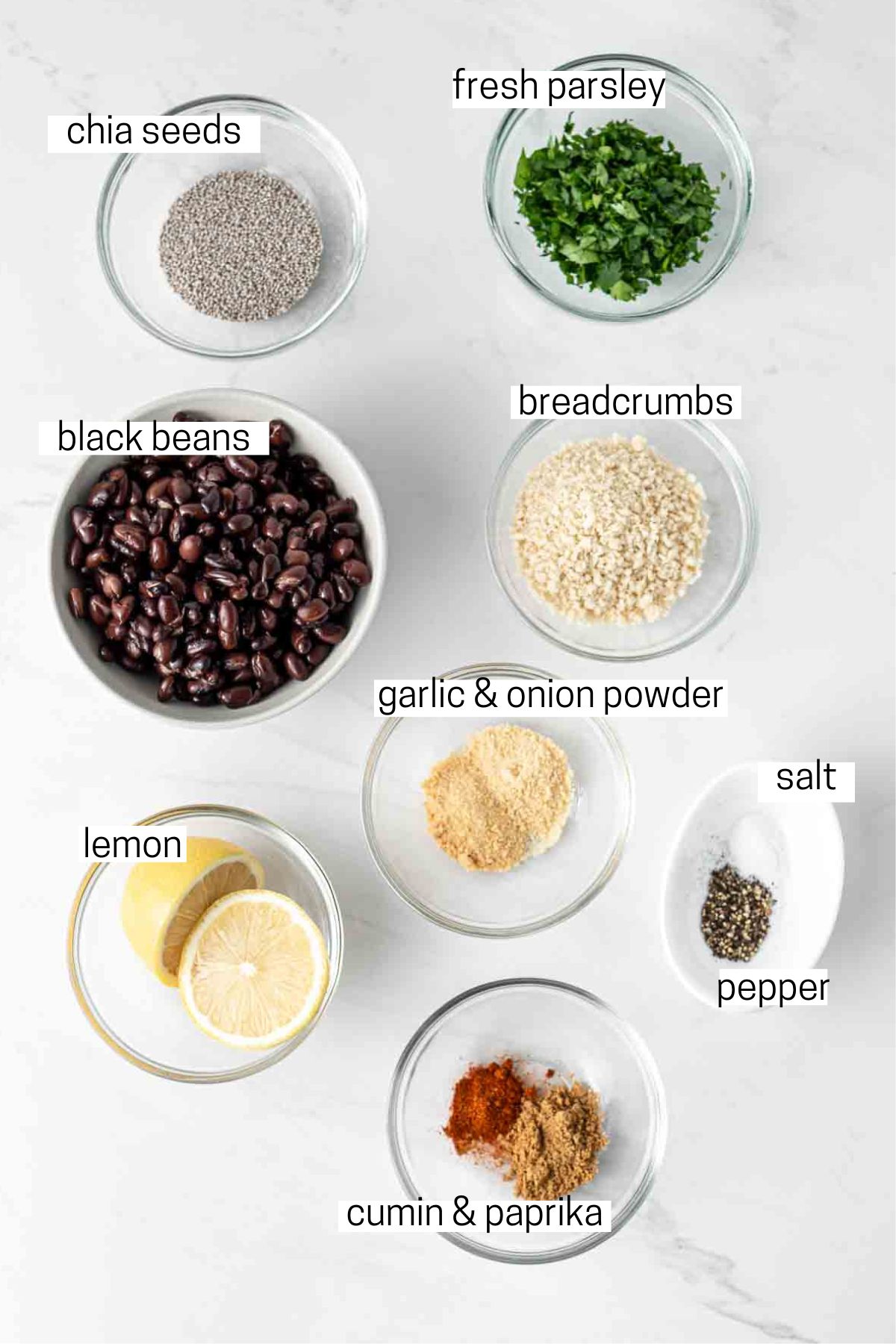All ingredients needed to make black bean burgers laid out in small bowls.