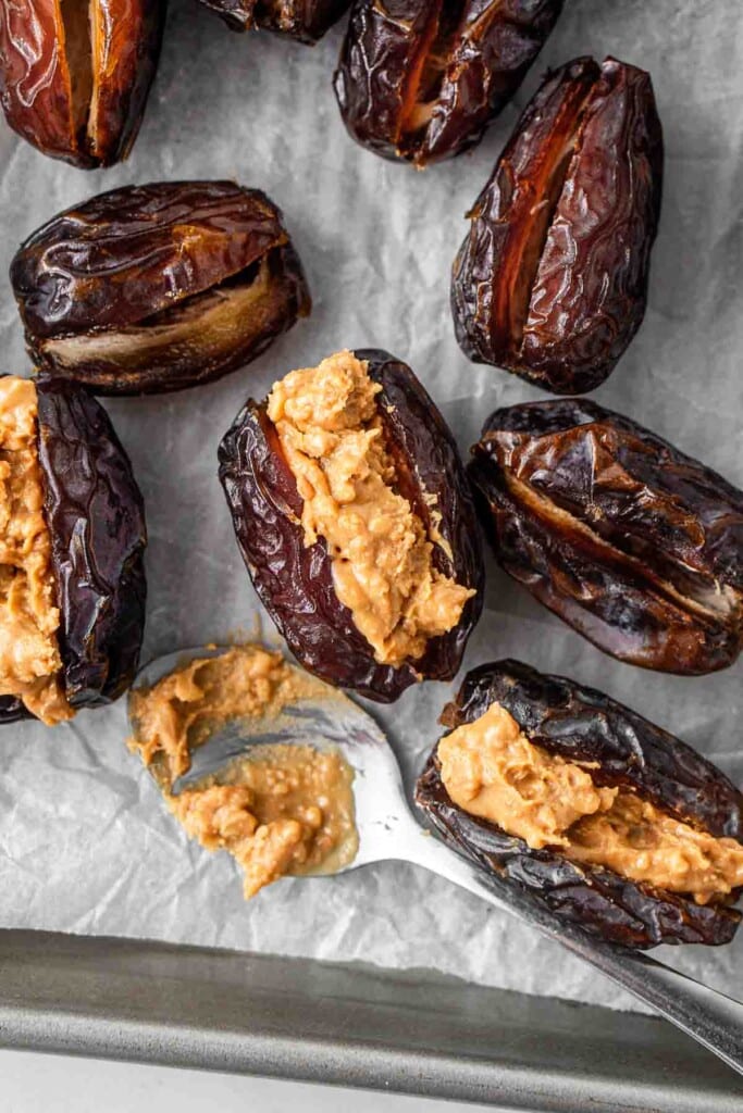 Spooning peanut butter into the dates.
