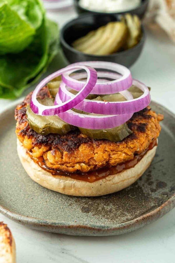 Pickles and red onion on top of a burger.