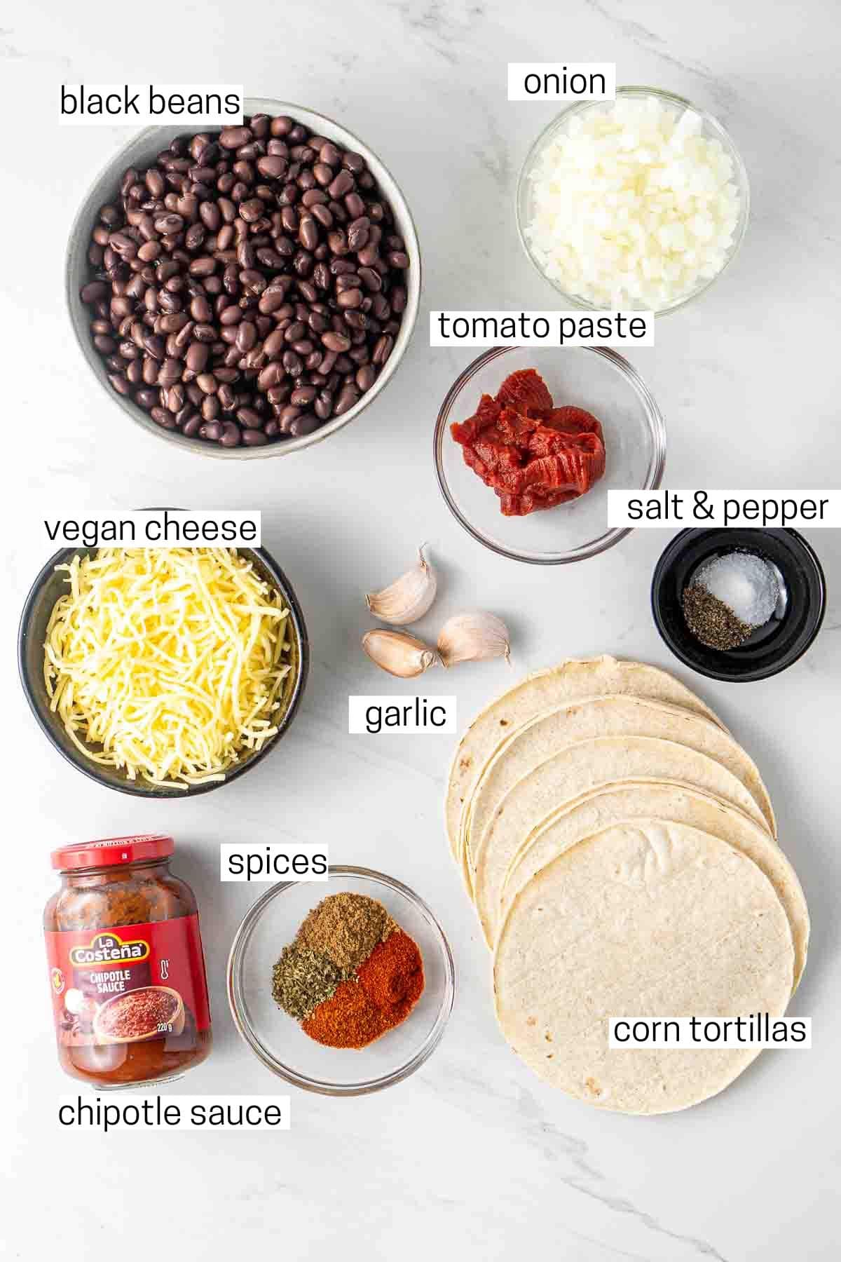 All ingredients needed for black bean tacos laid out in small bowls.