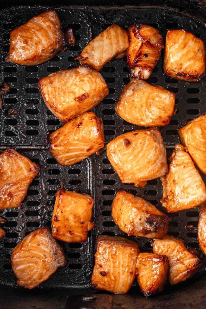 Close up of cooked salmon in the basket of the air fryer.