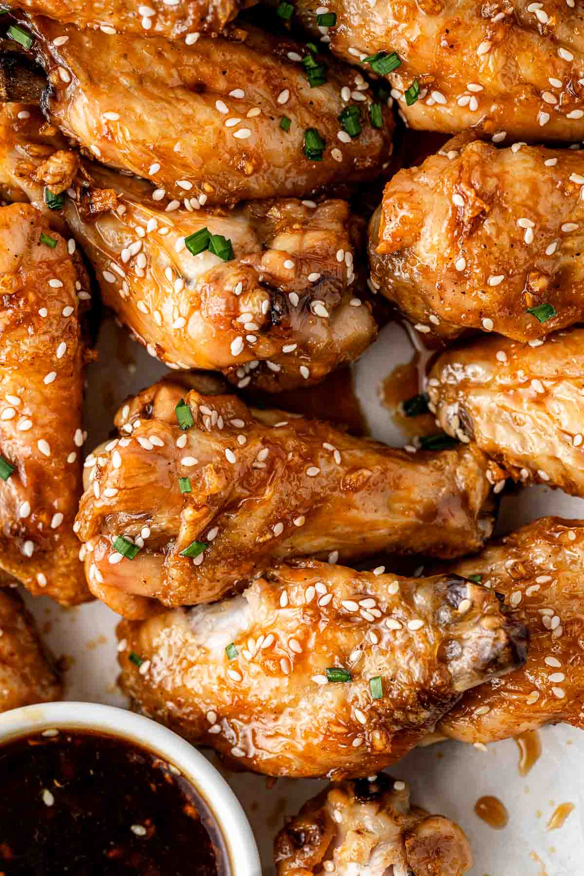 Close up of honey soy chicken wings with sesame seeds.