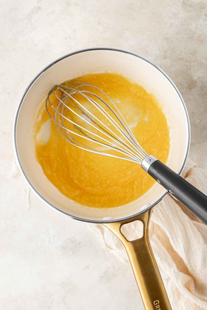 Whisking the butter and flour to form a roux.