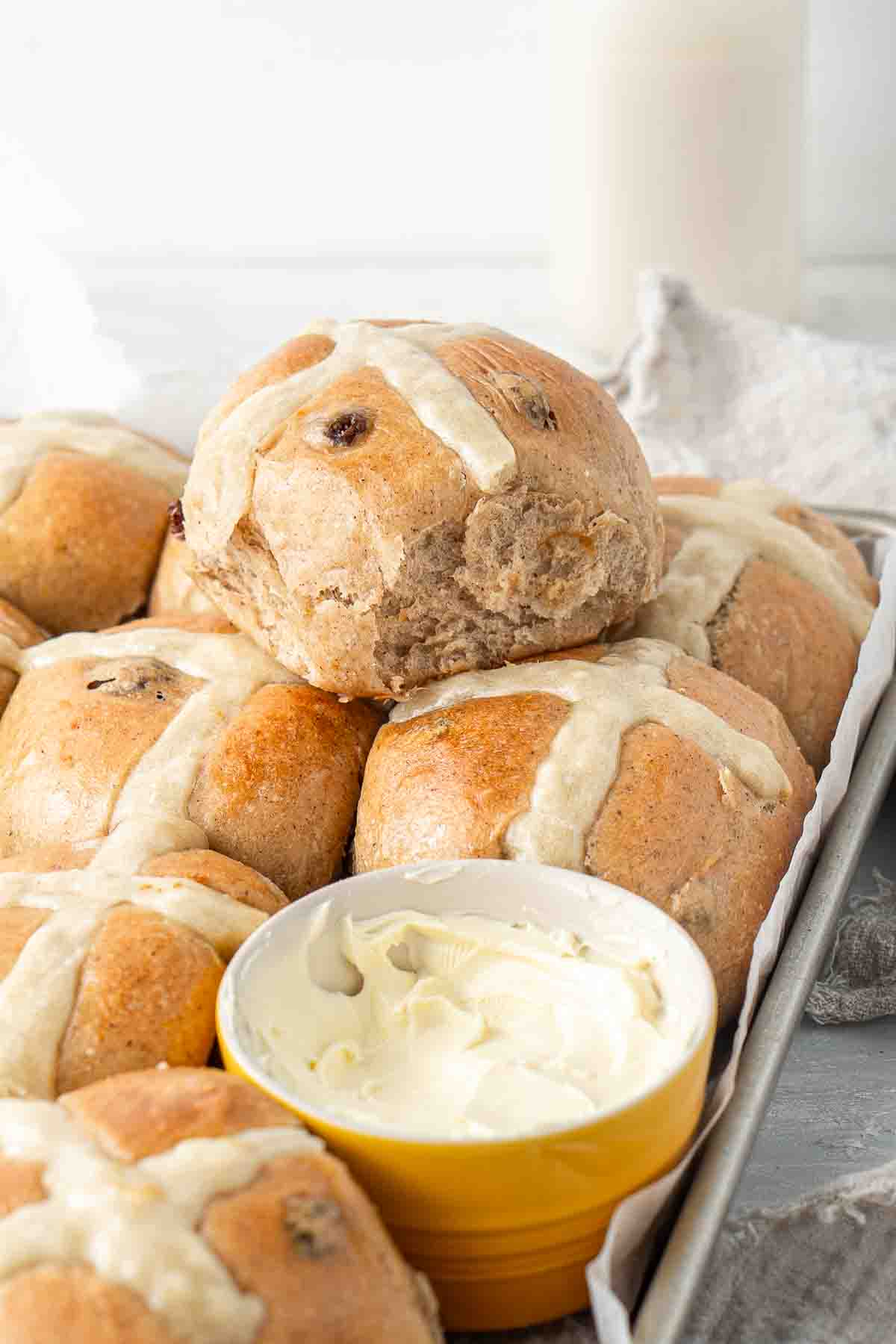 Close up of vegan hot cross buns with dairy free butter.