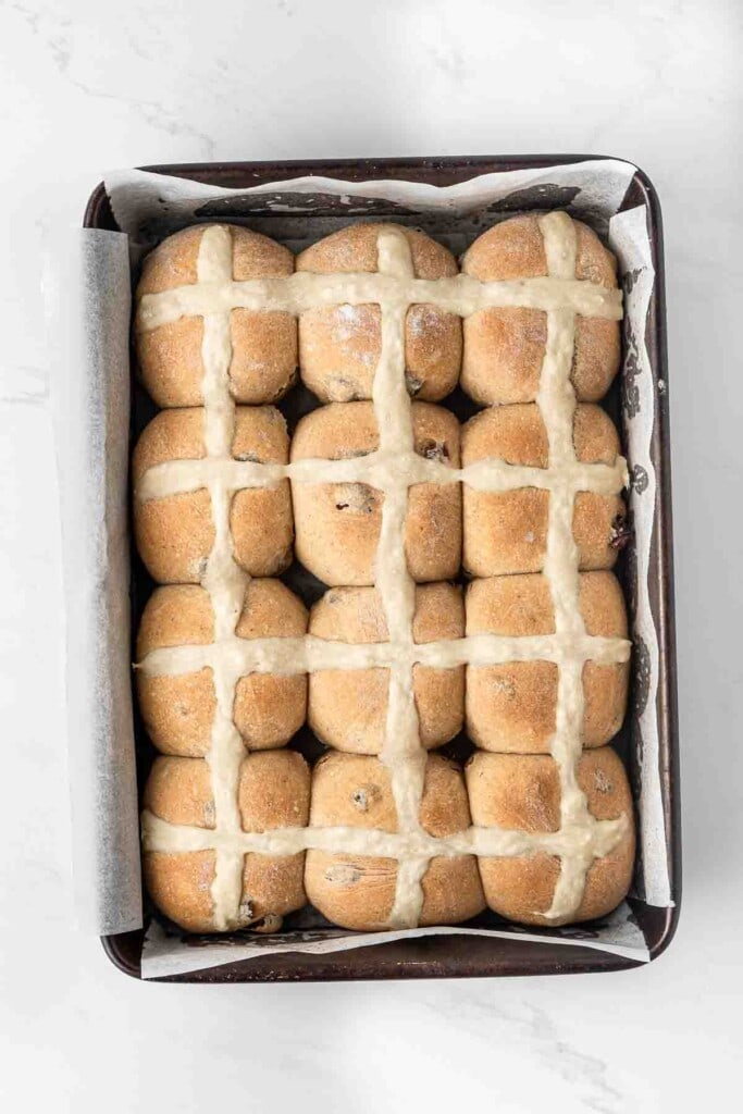 Vegan hot cross buns in a baking tray.