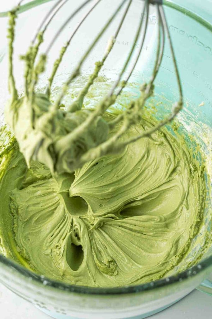 Creamy green matcha buttercream in a stand mixer.