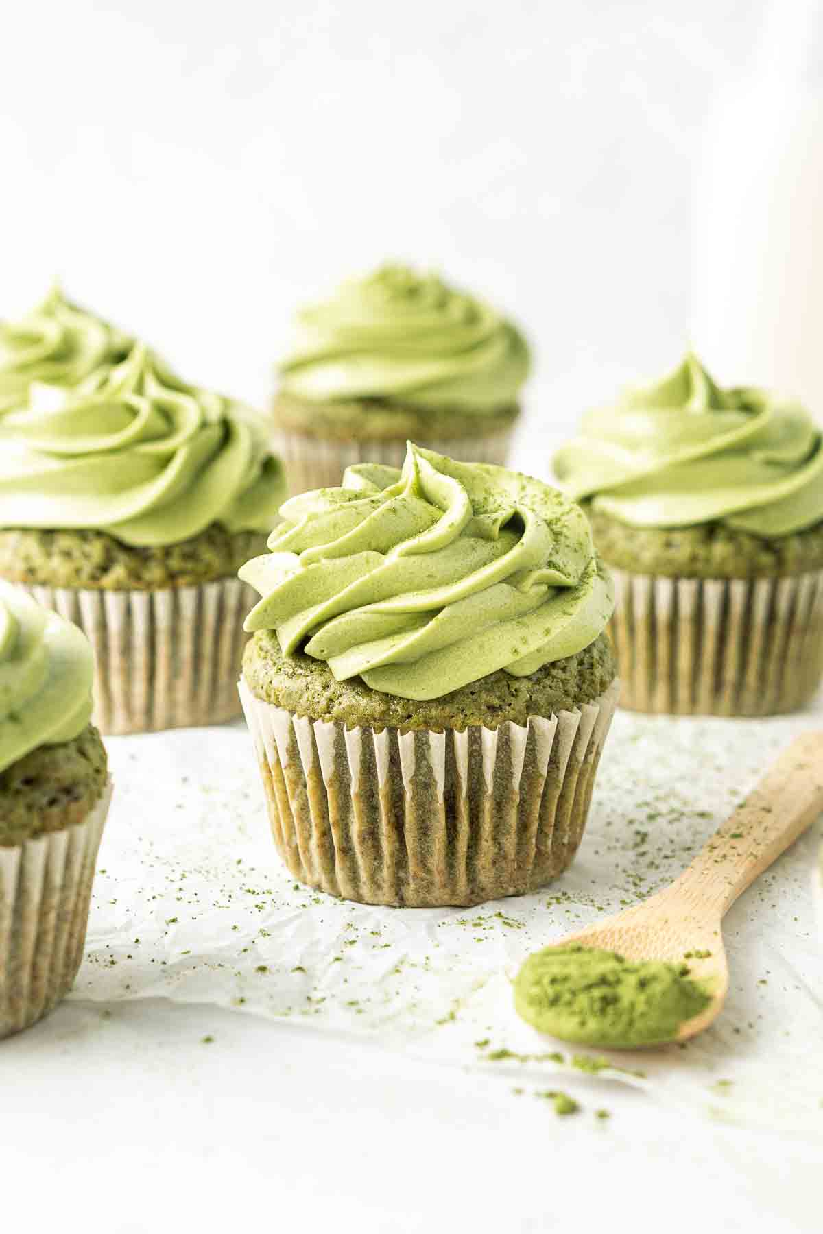 Close up of a vegan matcha cupcake with green maccha buttercream frosting.