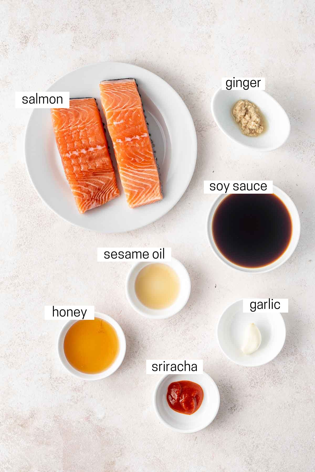 All ingredients needed to make air fryer salmon laid out in small bowls.