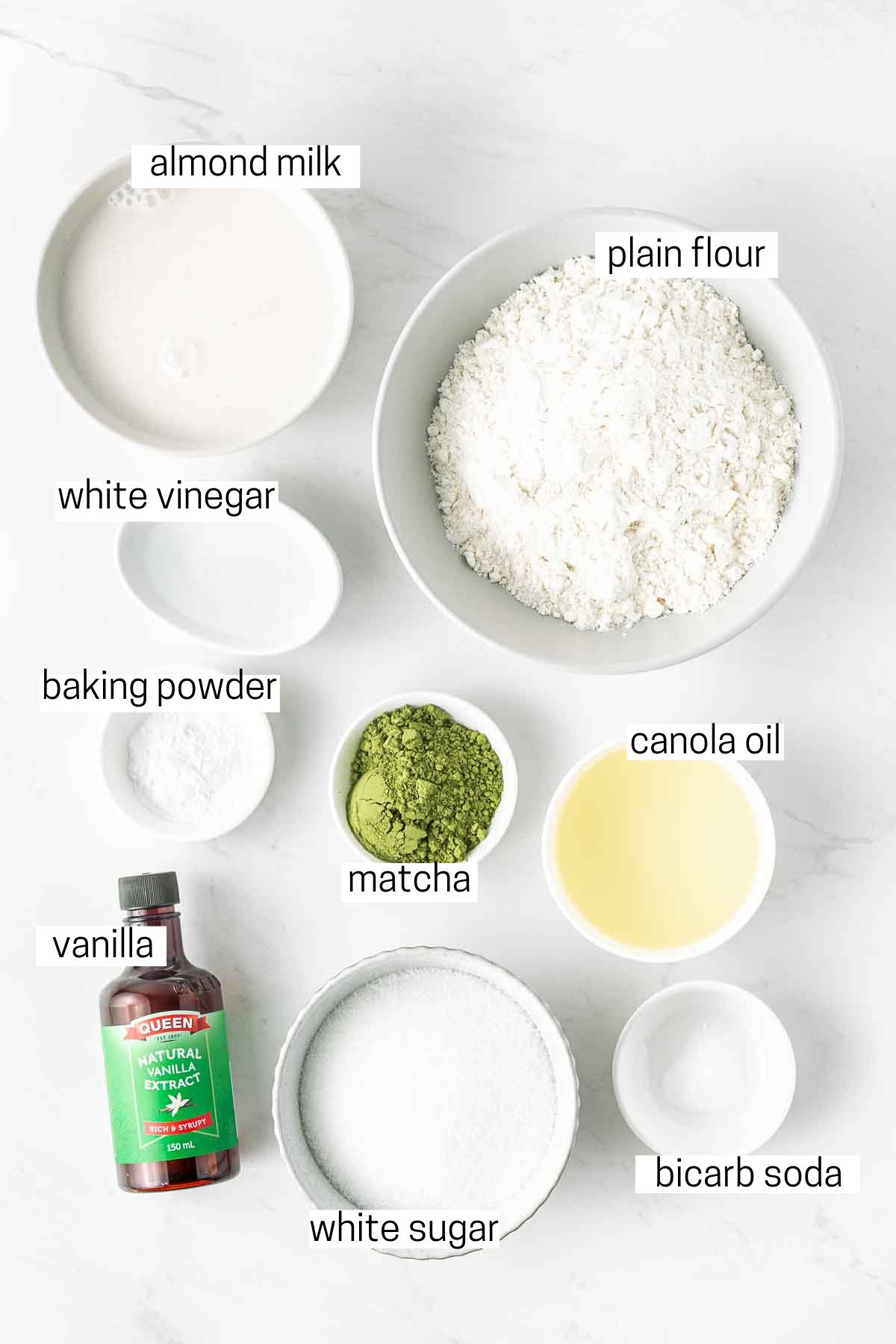 All ingredients needed for the vegan matcha cupcakes laid out in small bowls.