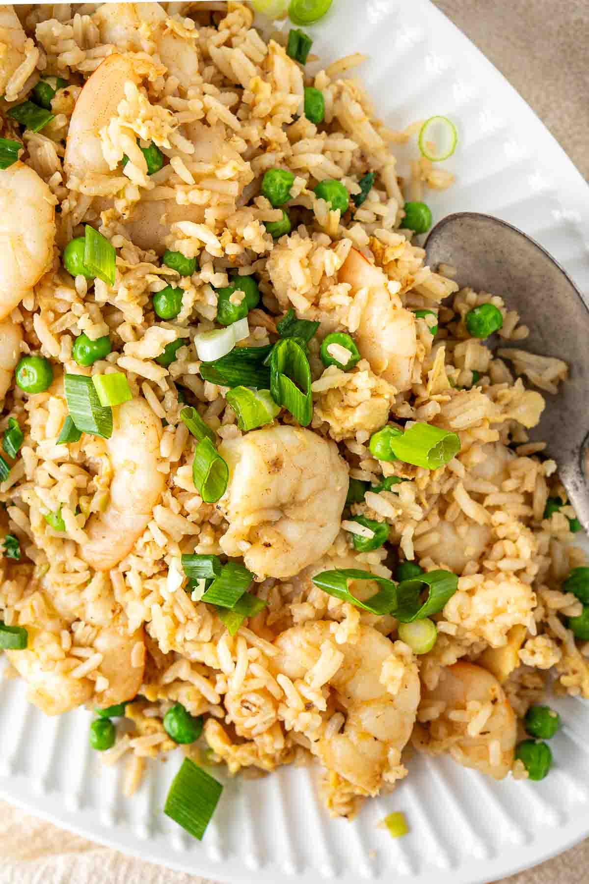 Close up of egg fried rice with prawns on a plate.