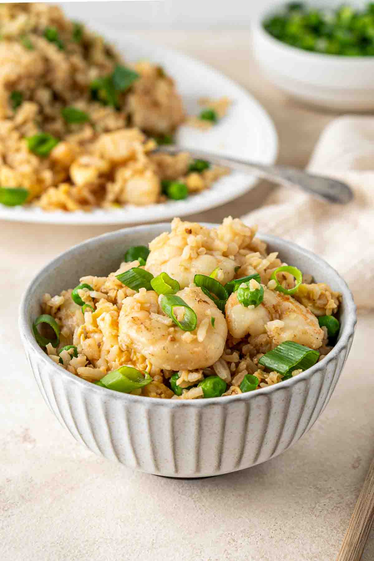 A bowl of egg fried rice with prawns.