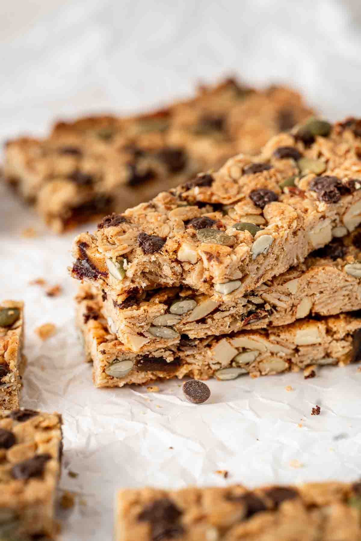 Close up of a stack of three granola bars, one with a bite taken.
