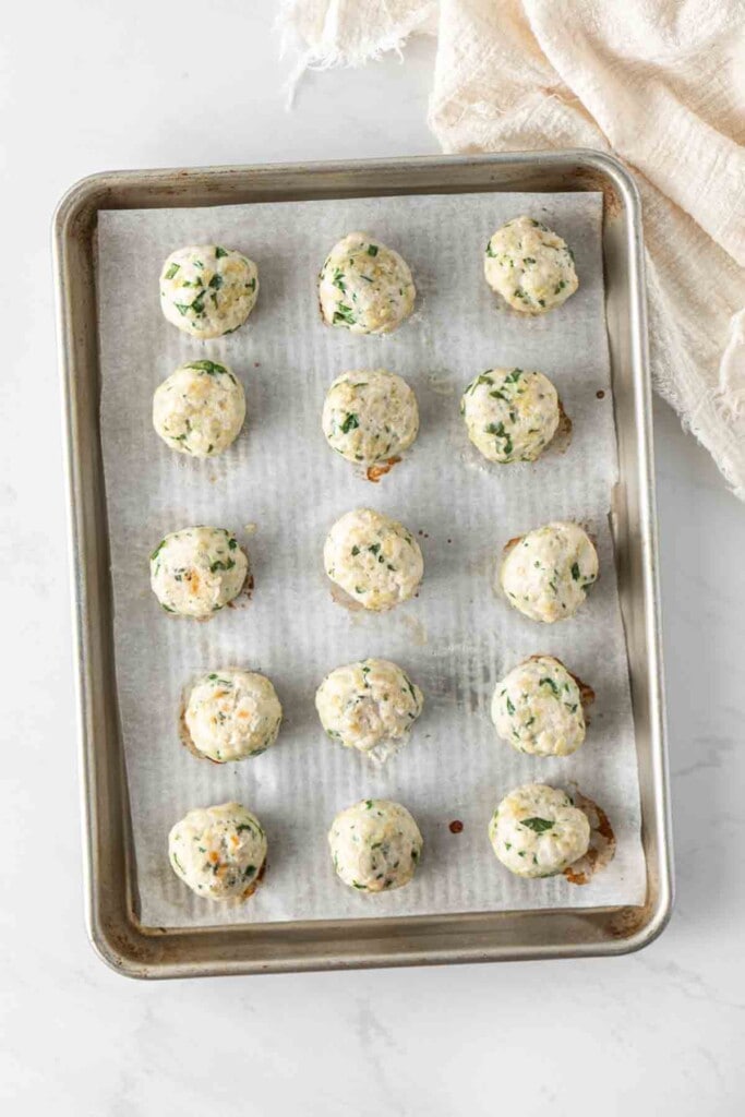 Cooked turkey meatballs on a baking tray.