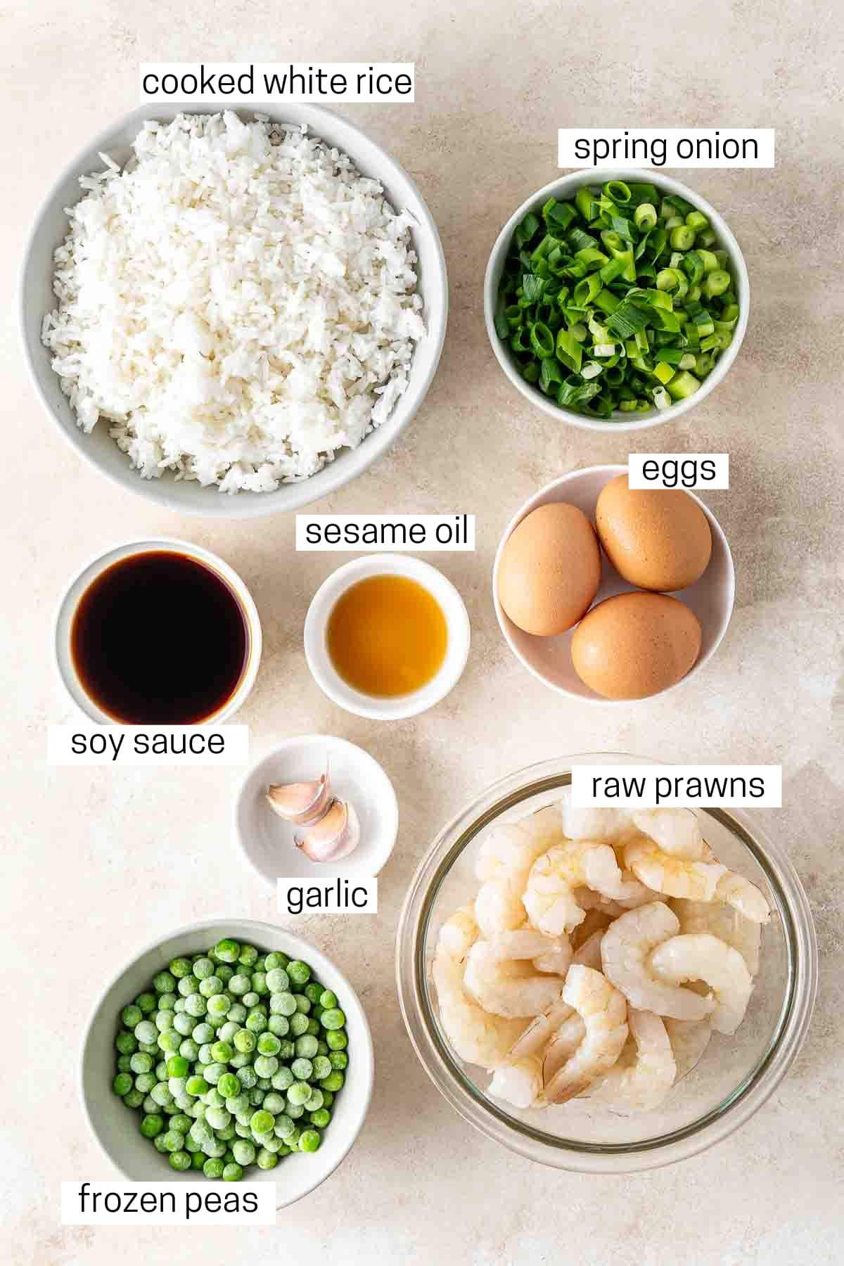 All ingredients needed to make prawn and egg fried rice.
