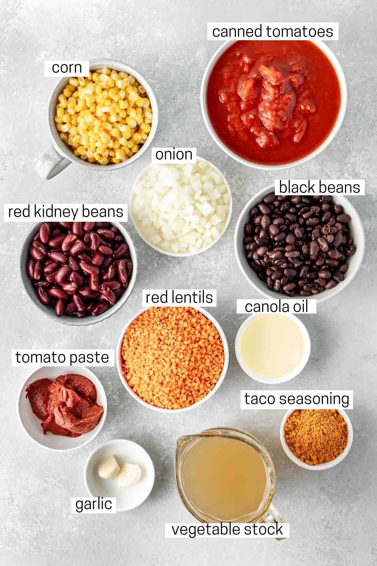 All ingredients needed for vegan chilli laid out in small bowls.
