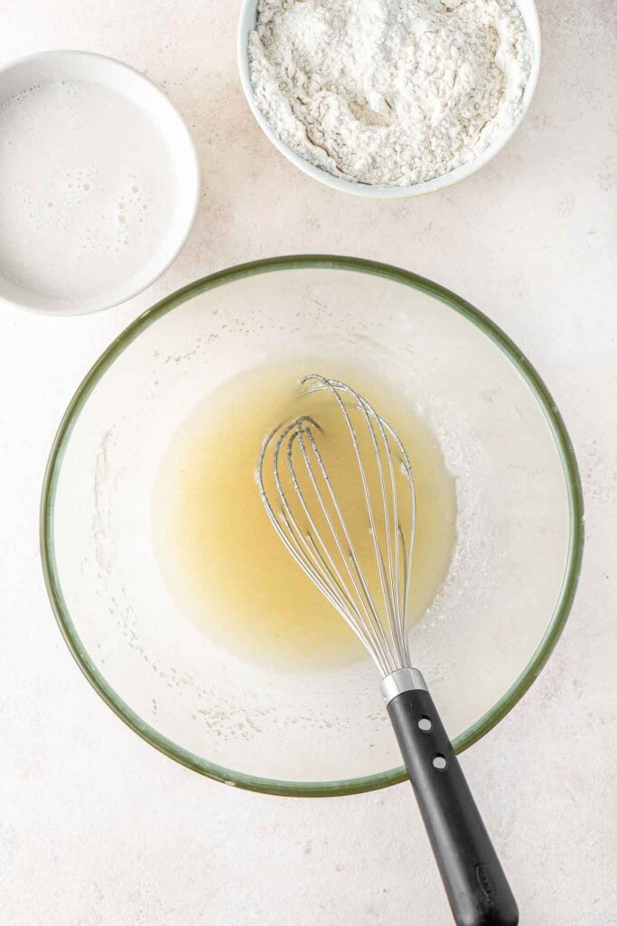 Whisking together the wet ingredients in a large mixing bowl.