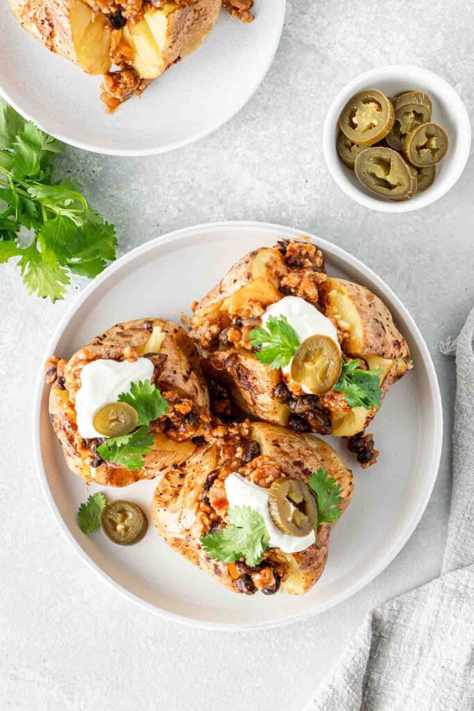 Loaded mexican potatoes on a plate.