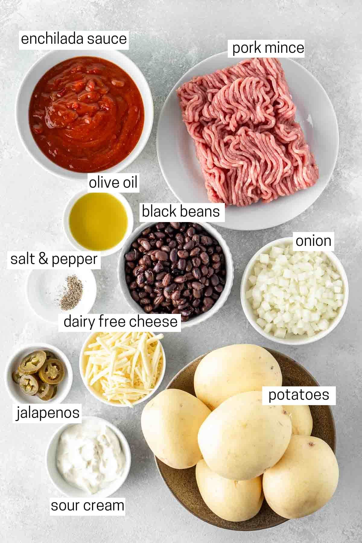 All ingredients needed to make Mexican-style loaded potatoes laid out in small bowls.