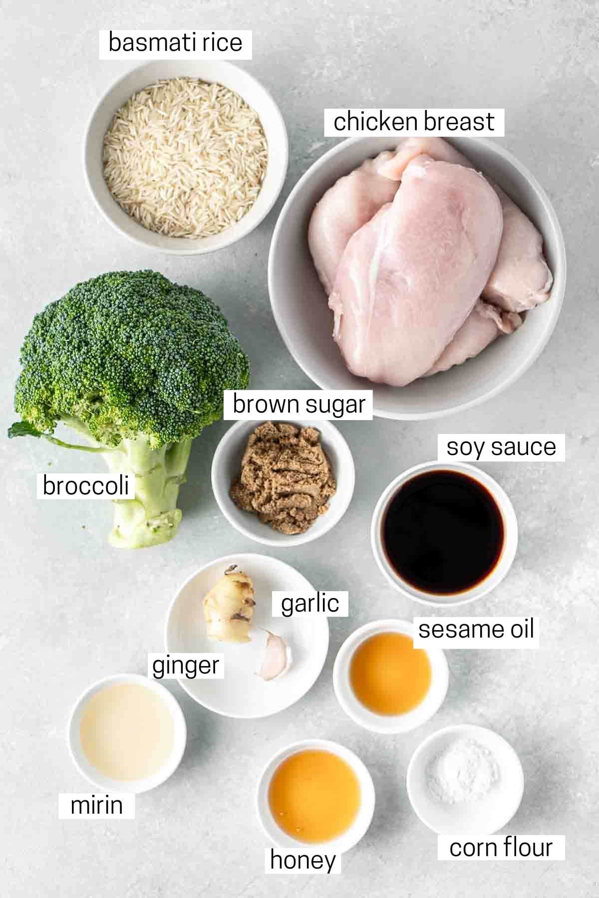 All ingredients needed for teriyaki chicken meal prep laid out in bowls.