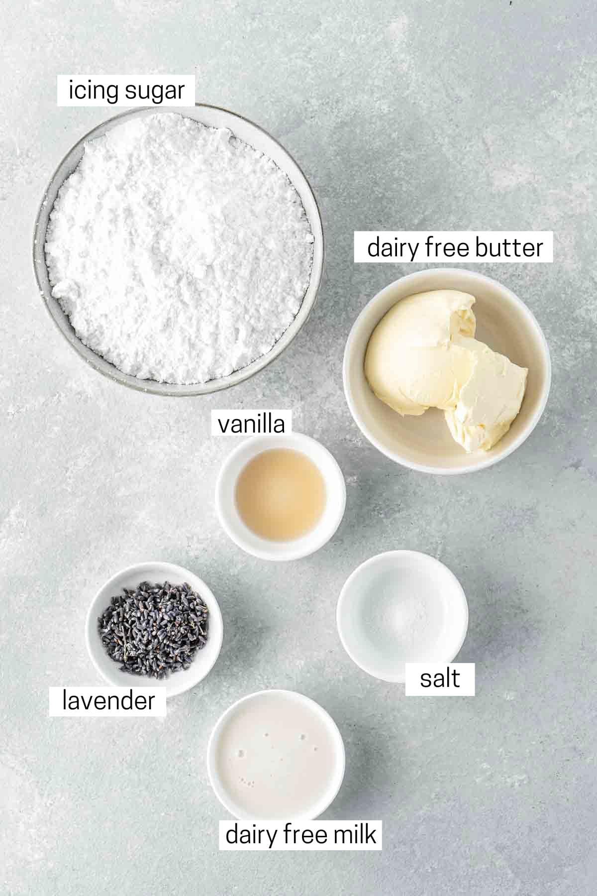 All ingredients needed for lavender buttercream laid out in small bowls.
