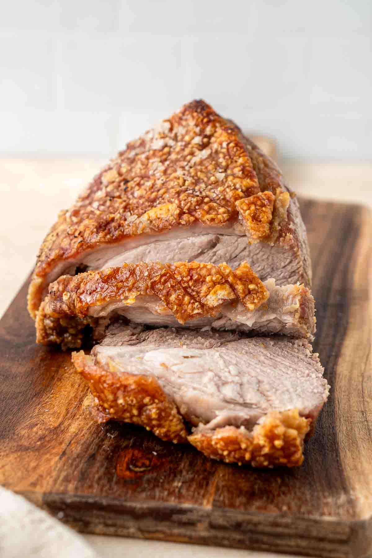 Close up of carved slices or roast pork with crispy crackling.