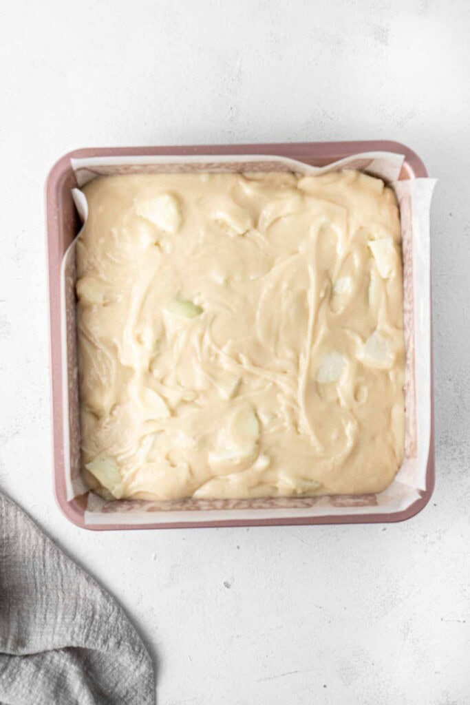 The apple cake batter in the baking pan.