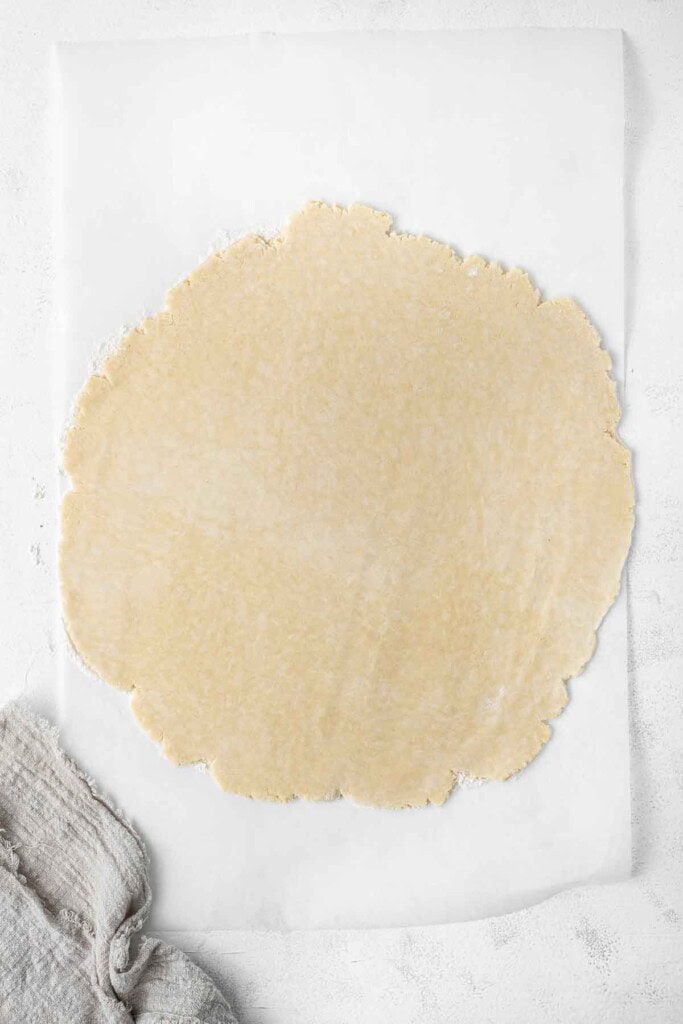 Rolling out the pastry into a circle.
