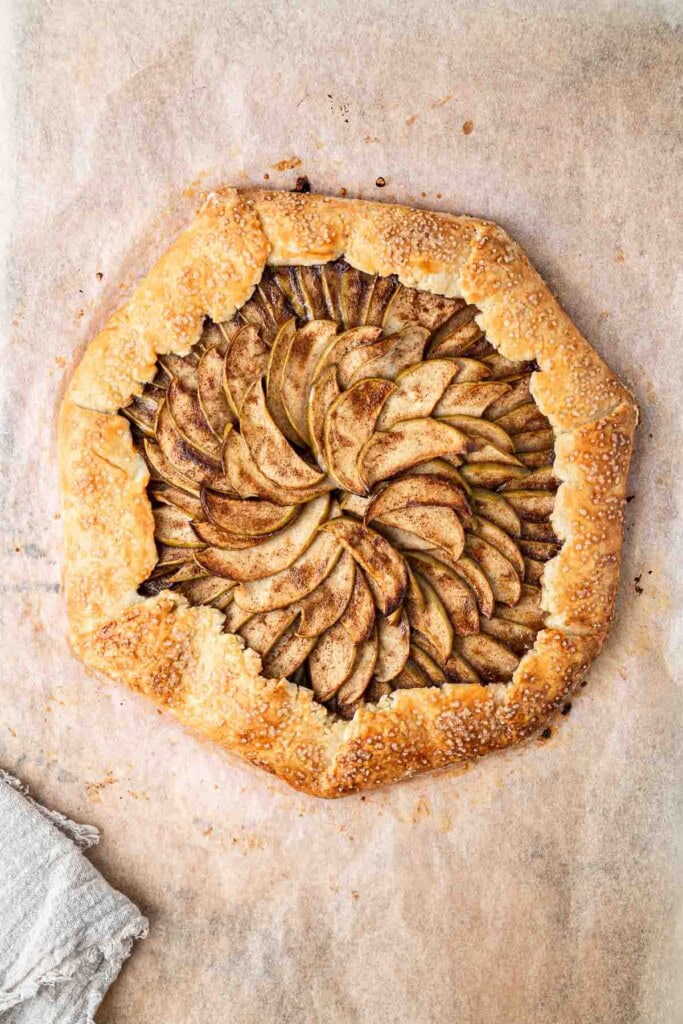 Freshly baked apple galette on a baking tray.