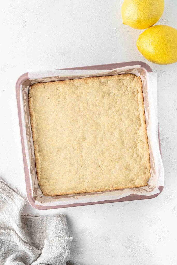 The blind baked base in a square pan.