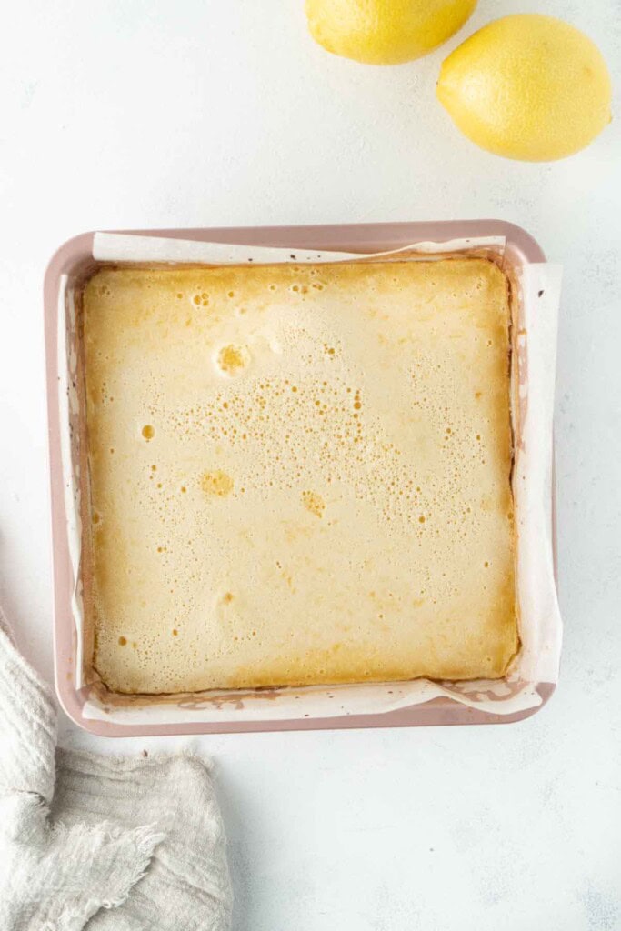 The baked lemon slice in a square baking pan.