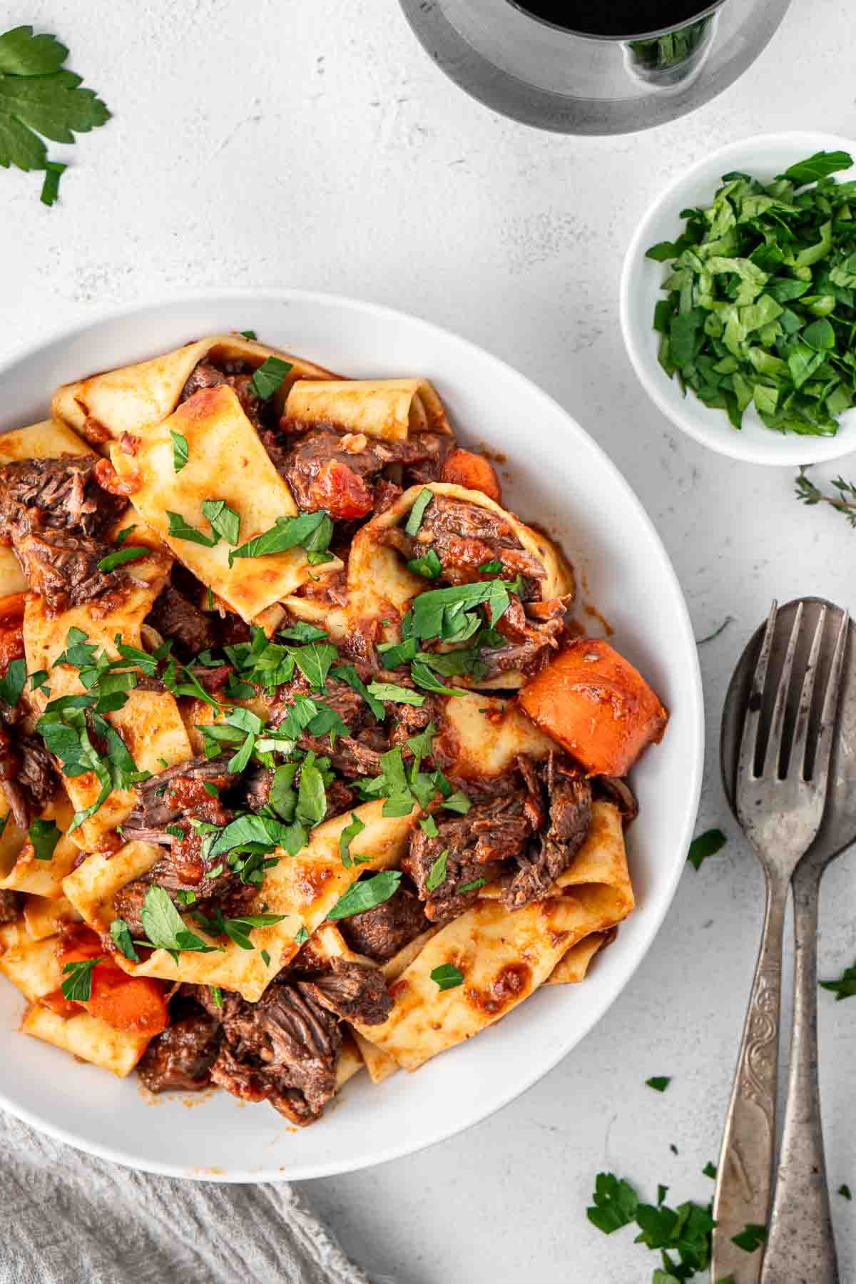 Close up of beef ragu in a white bowl.