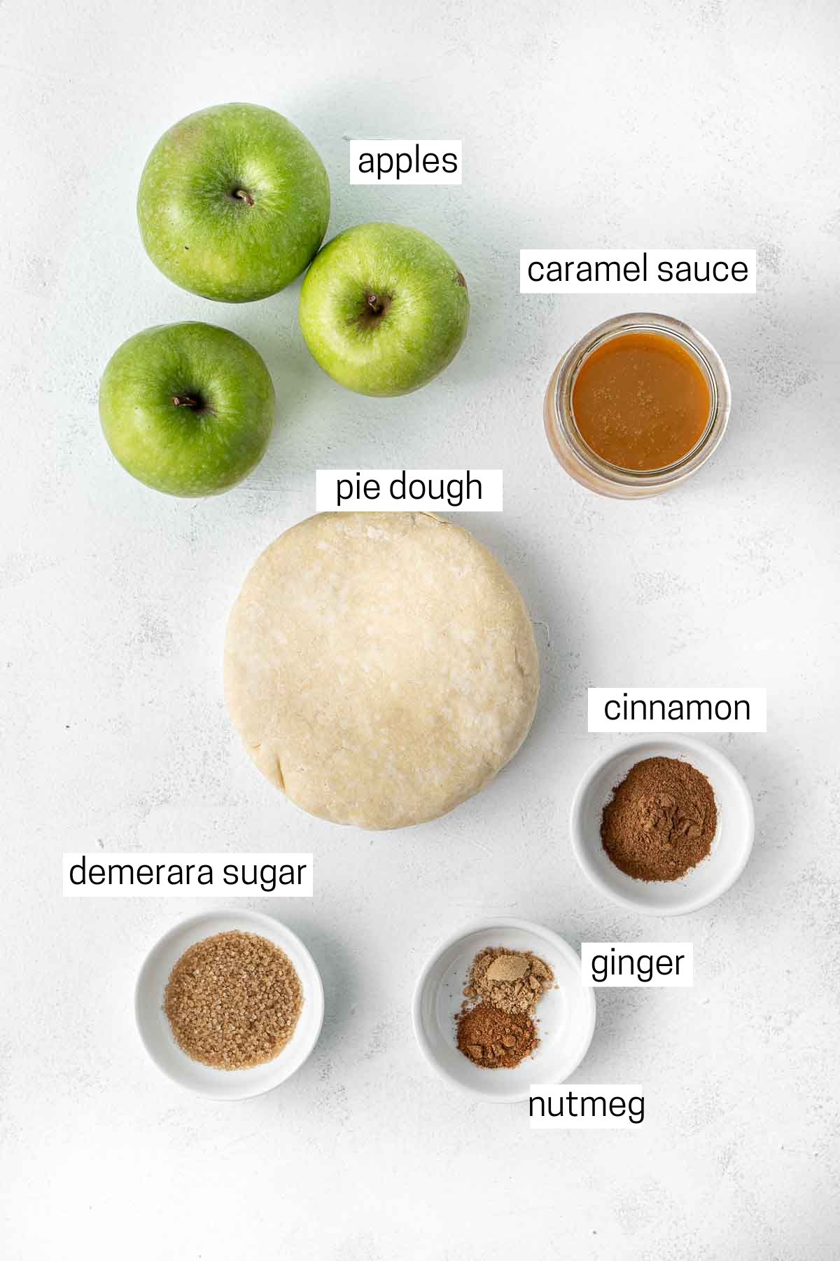 All ingredients needed to make caramel apple galette laid out in small bowls.