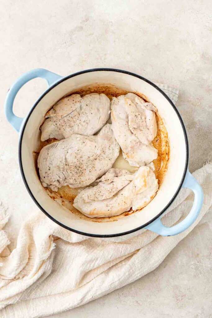 Cooking the chicken breast in the dutch oven.