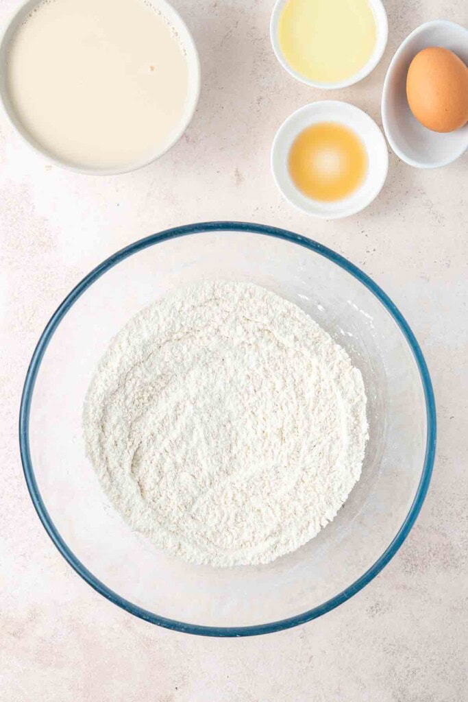 Mixing together the dry ingredients in a glass bowl.