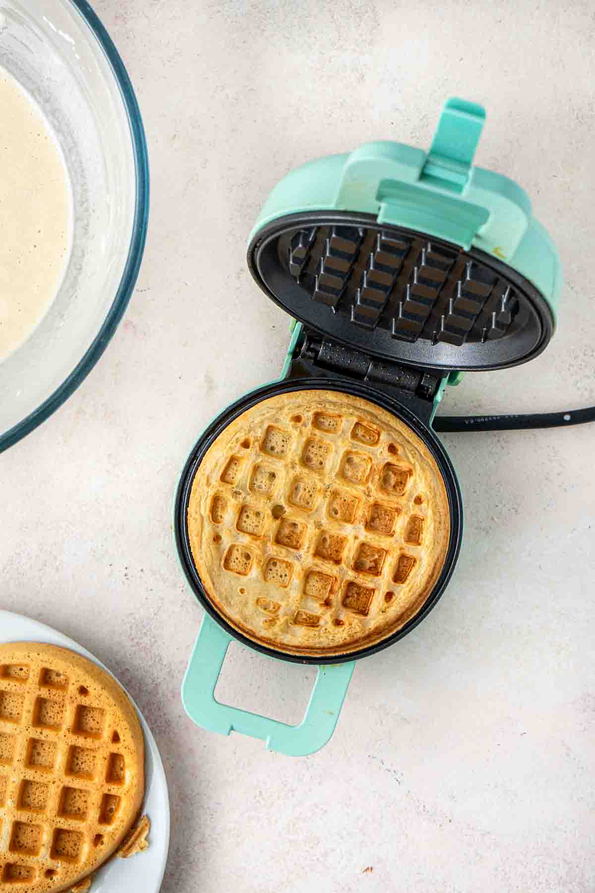 Cooking the waffles in a mini waffle iron.