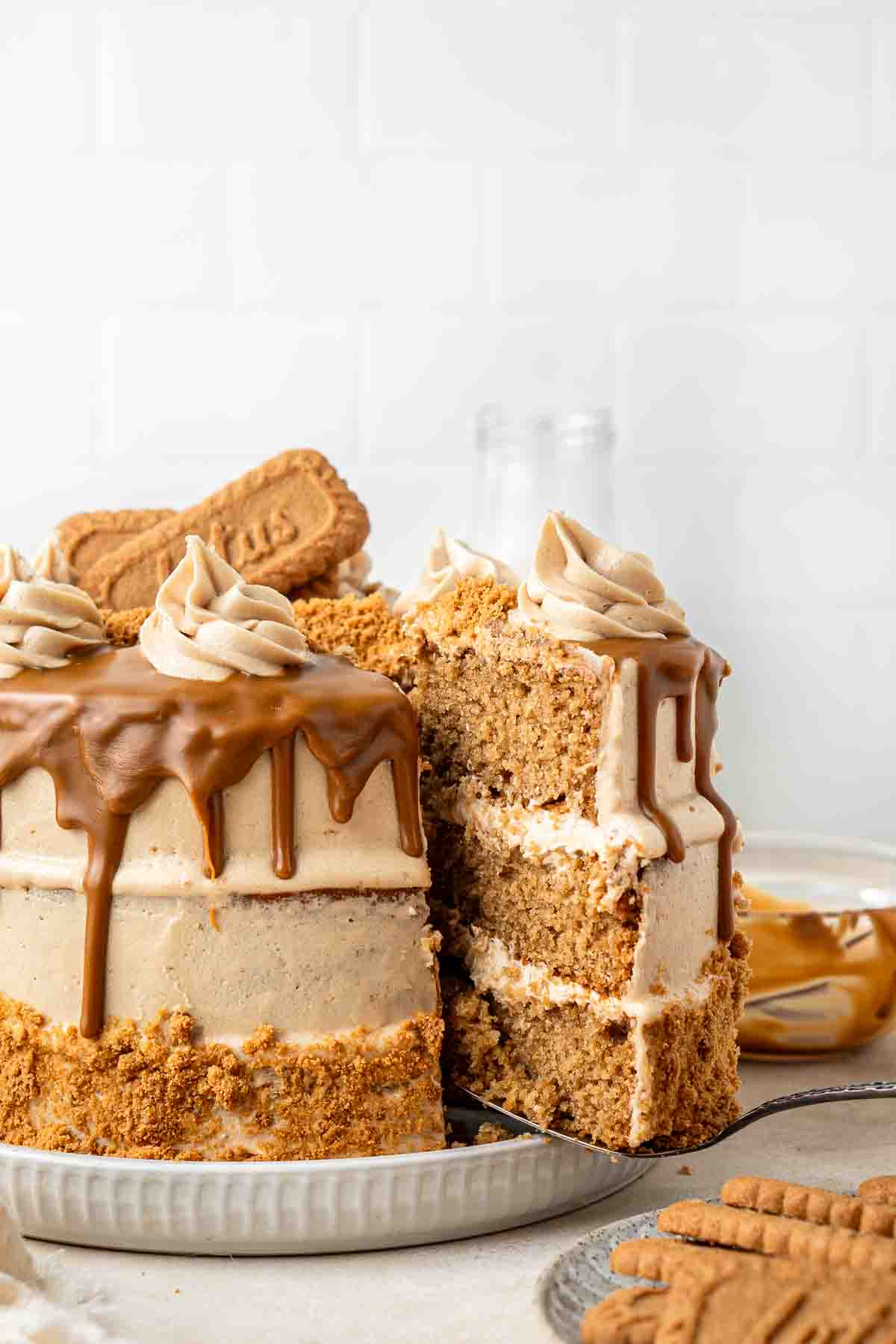 Cutting and serving a slice of biscoff cake.