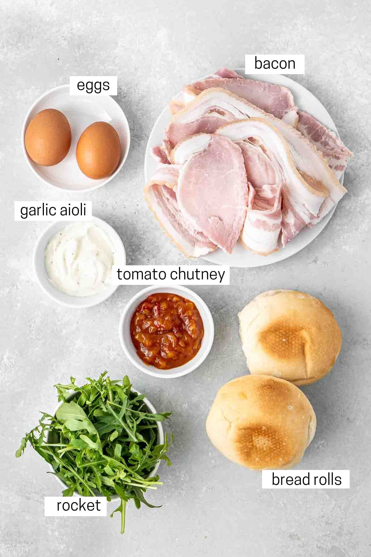 All ingredients needed to make bacon and egg rolls laid out.