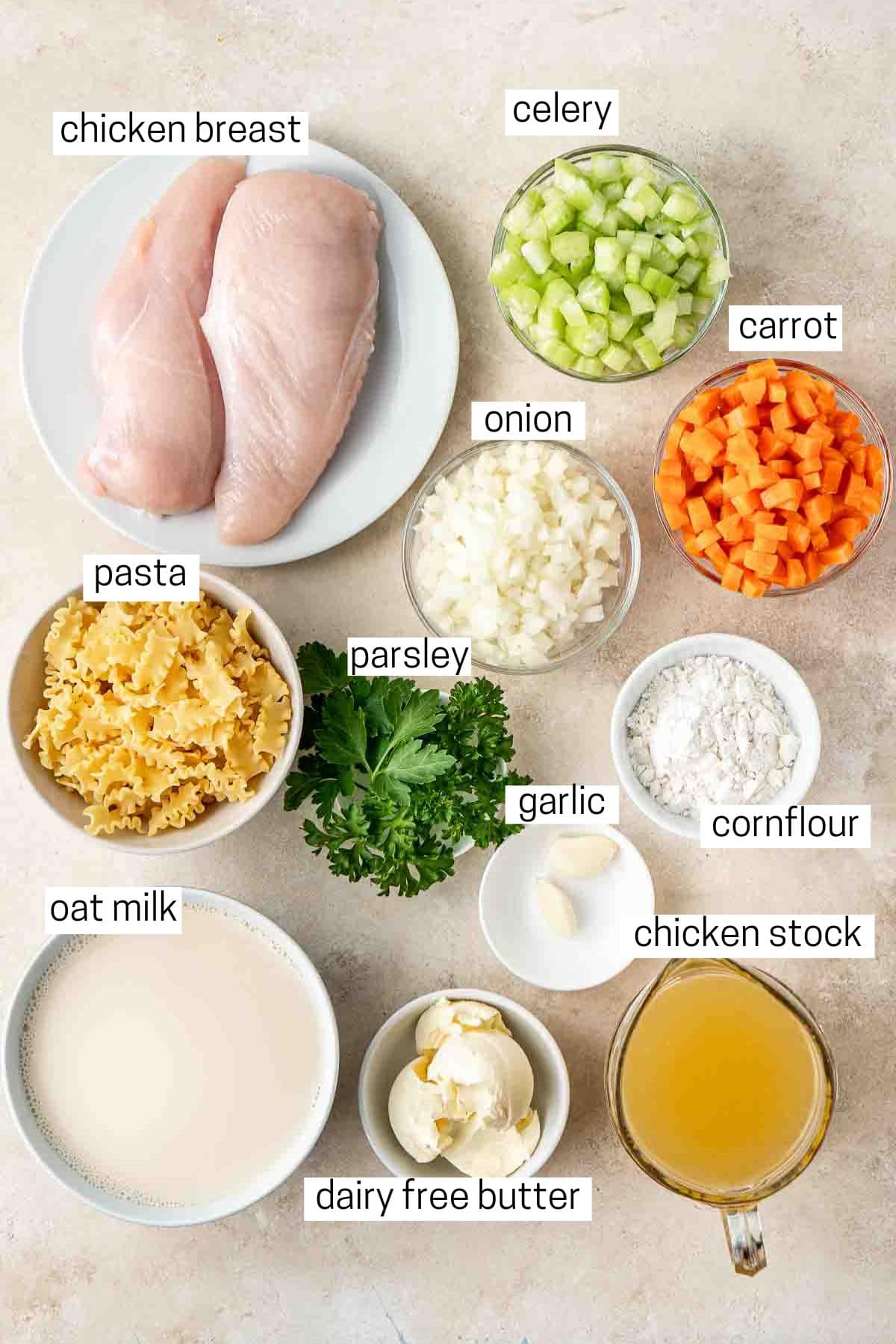 All ingredients needed to make creamy chicken soup laid out in small bowls.