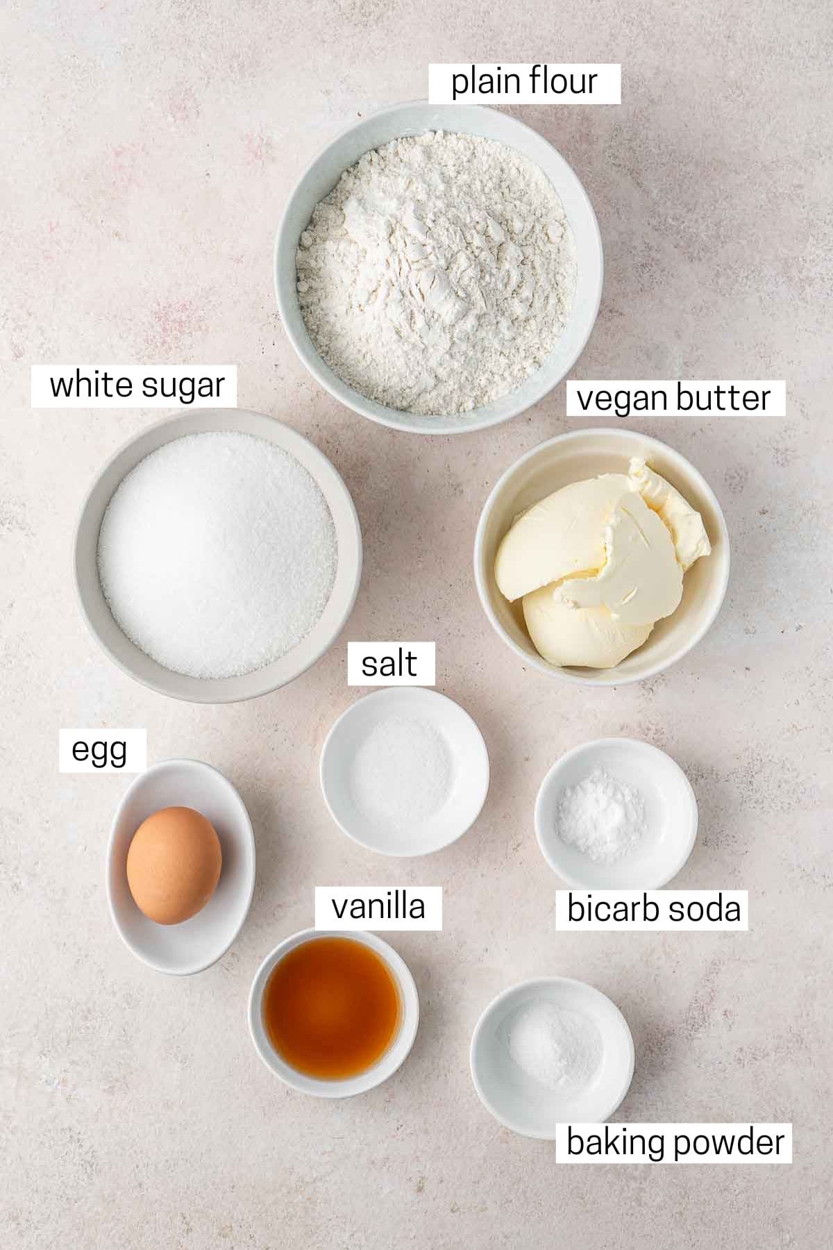 All ingredients needed for dairy free sugar cookies laid out in bowls.