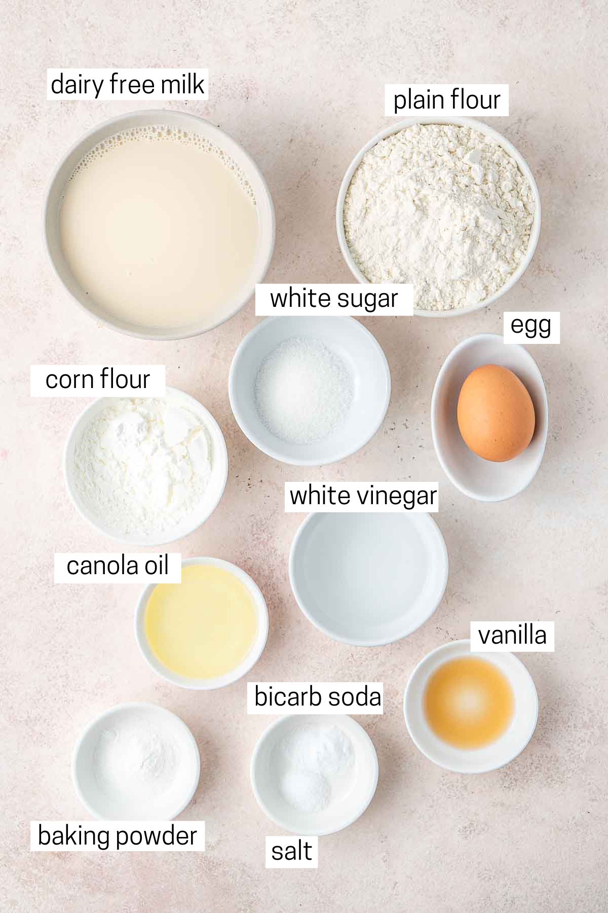 All ingredients needed to make dairy free waffles laid out in small bowls.