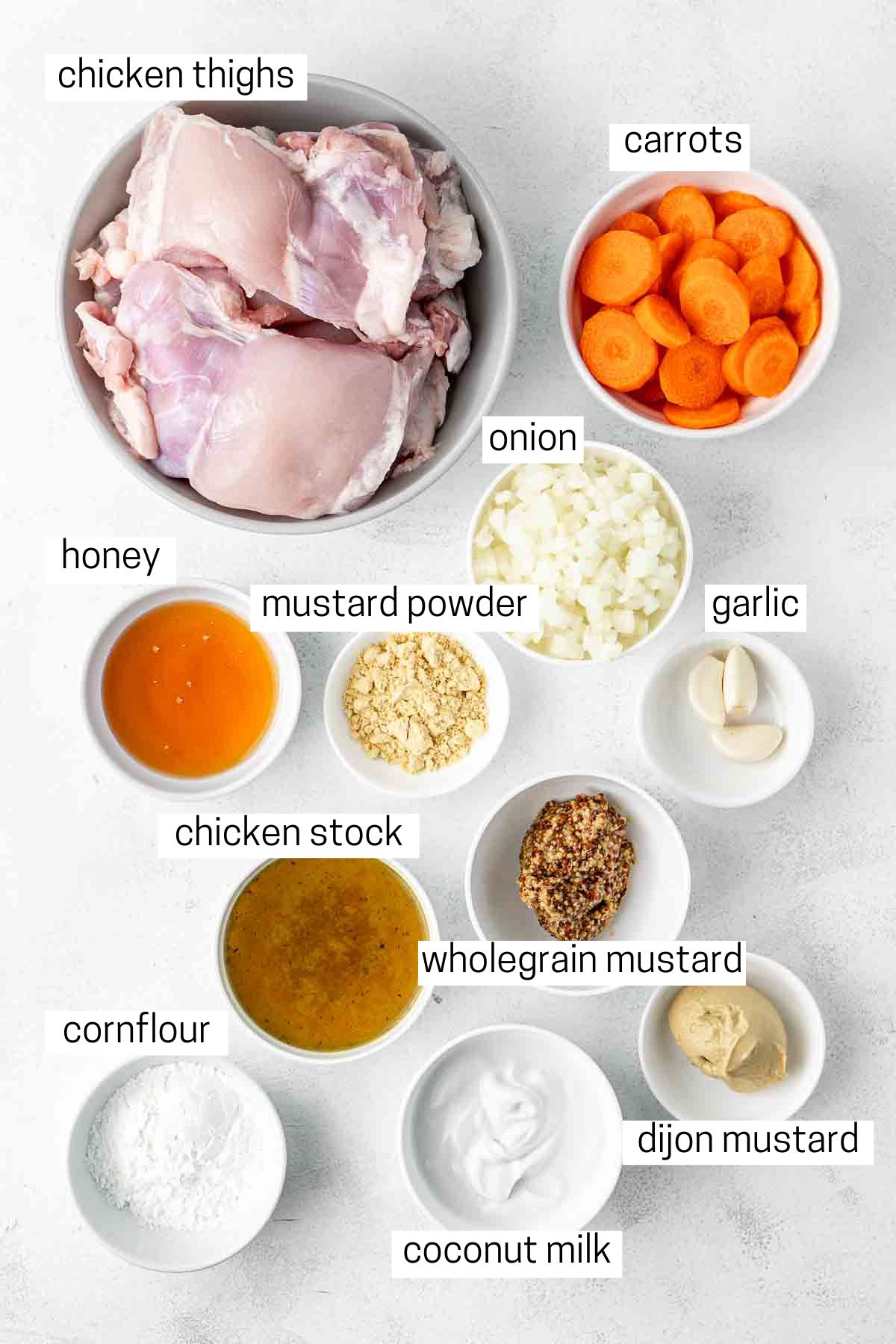 All ingredients needed for honey mustard chicken laud out in small bowls.